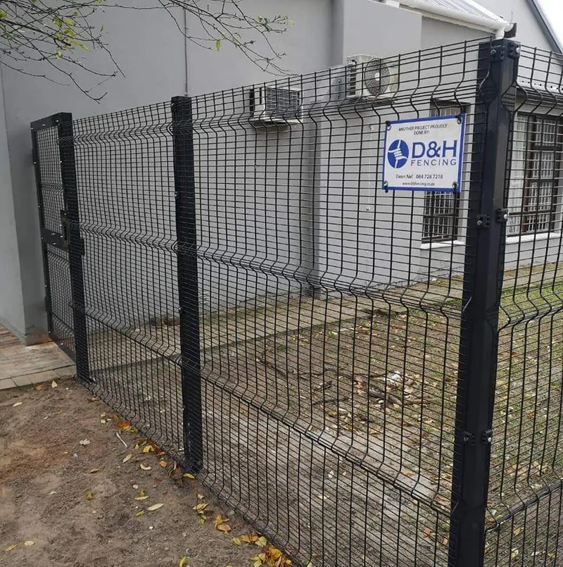 Newly installed black Clearview mesh fence with D&H Fencing sign at a Cape Town home
