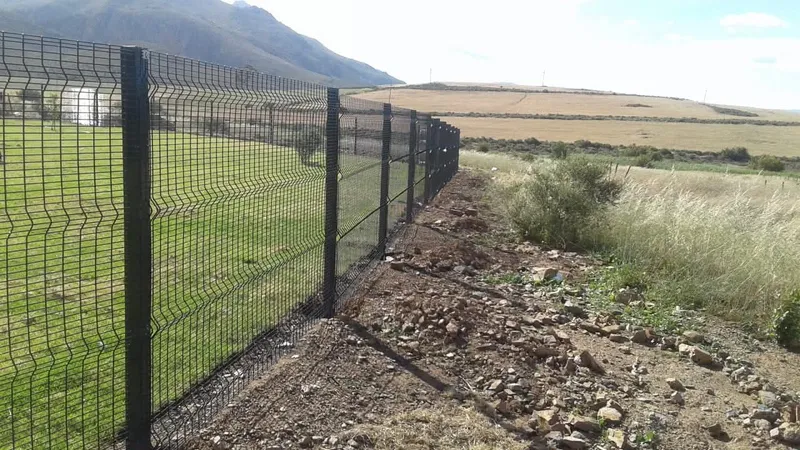 Black Clearview mesh boundary fence on rural smallholding with mountain backdrop in the Western Cape