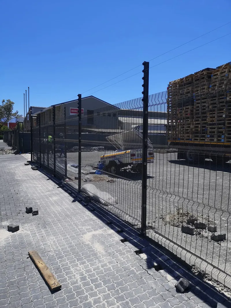 Clearview anti-climb mesh fence with electric top wires at Cape Town commercial yard
