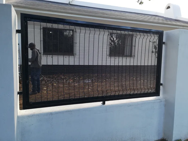 Clearview mesh fence panel installed on top of white boundary wall in Cape Town residential property
