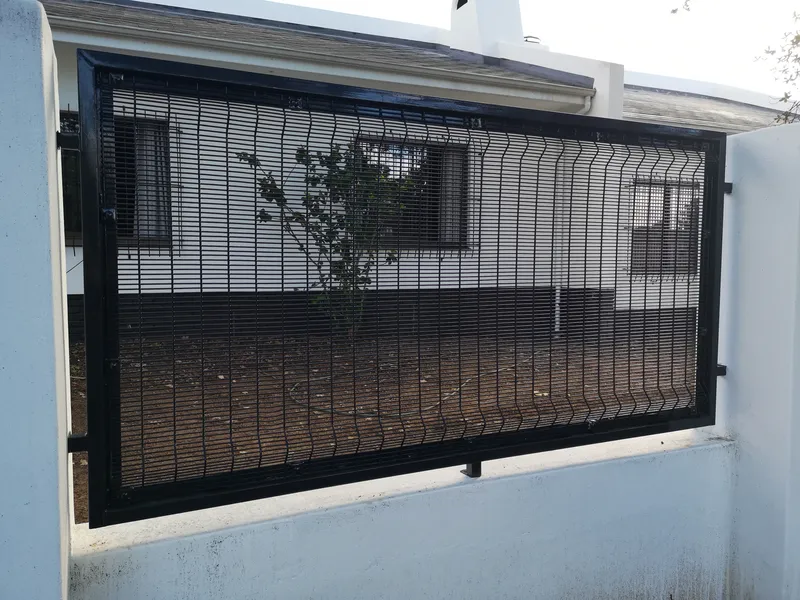 Clearview mesh panel on white boundary wall providing security extension at Cape Town home