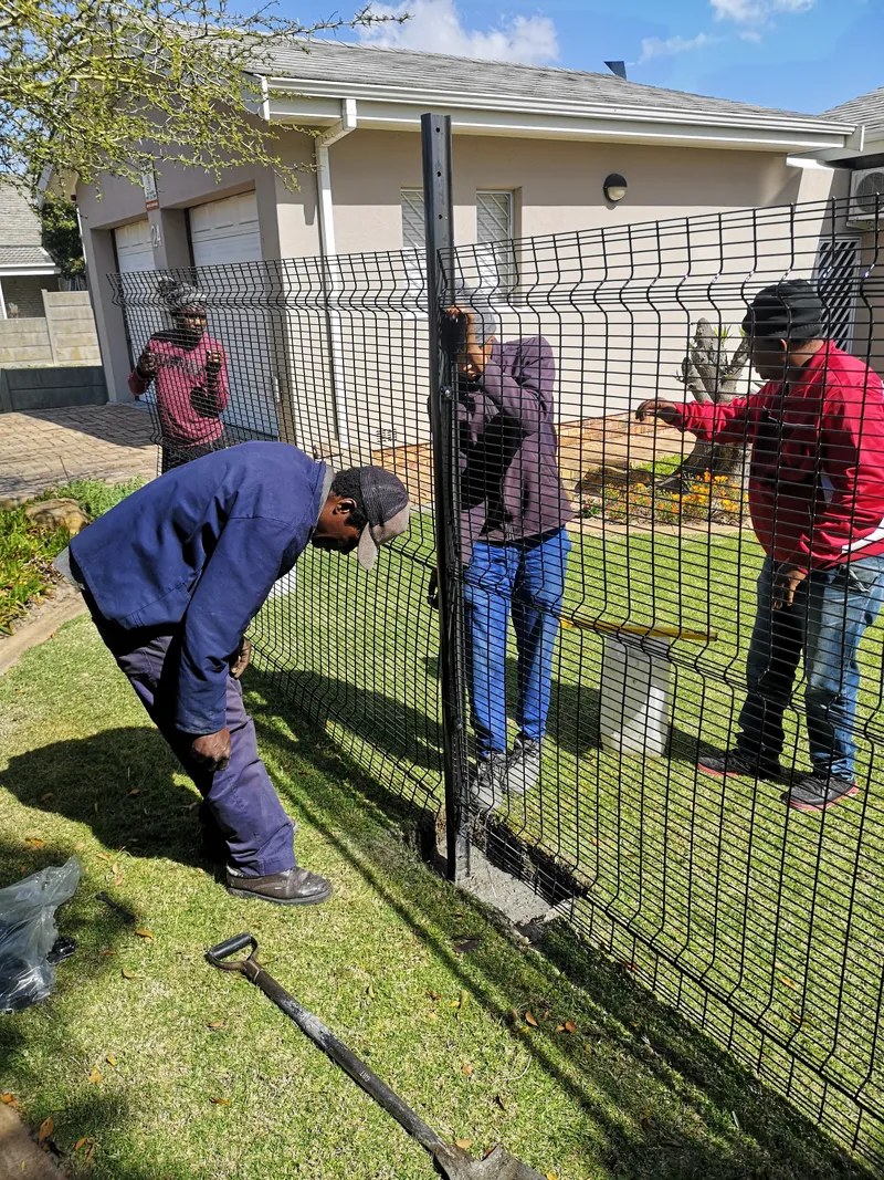 D&H Fencing team installing clearview mesh fence with cement post setting at Cape Town home