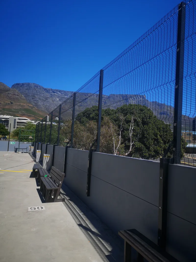 Clearview mesh fence on grey precast wall with Table Mountain backdrop in Cape Town