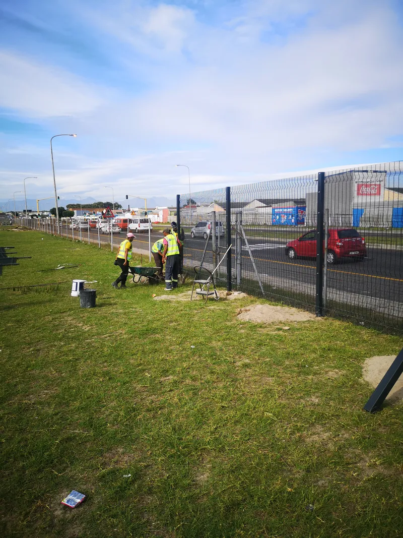 D&H Fencing team installing clearview fence along roadside in Cape Town Western Cape