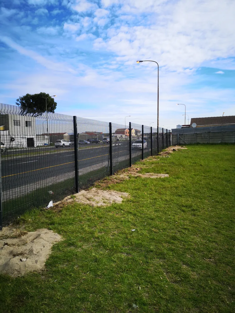Completed clearview fence section along main road in Cape Town with grass verge