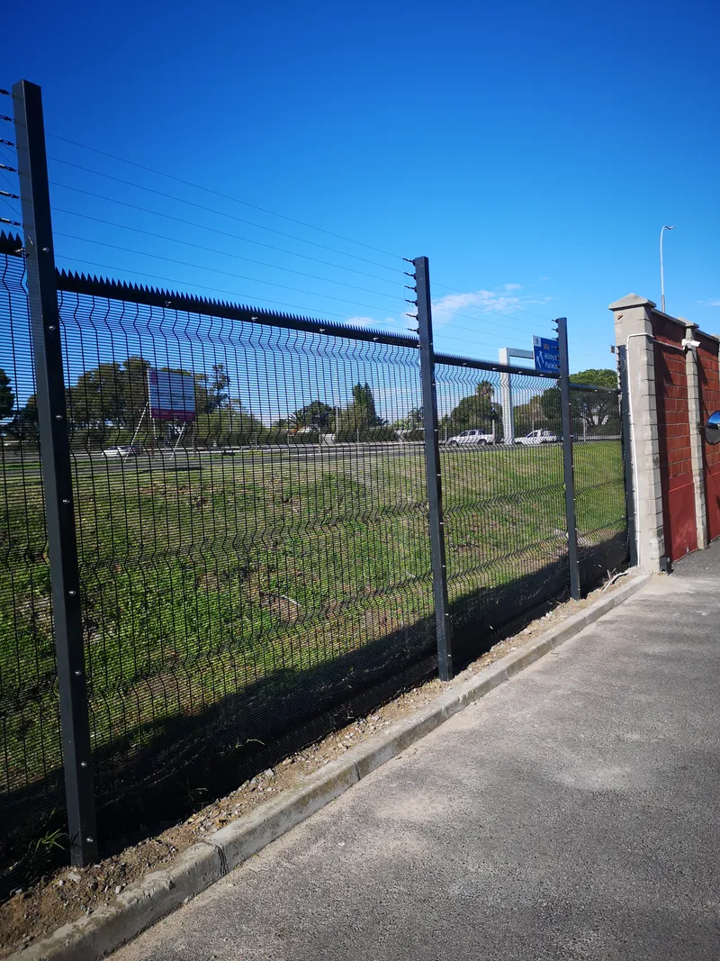 Clearview fence with brick pillar entry alongside commercial roadside in Cape Town