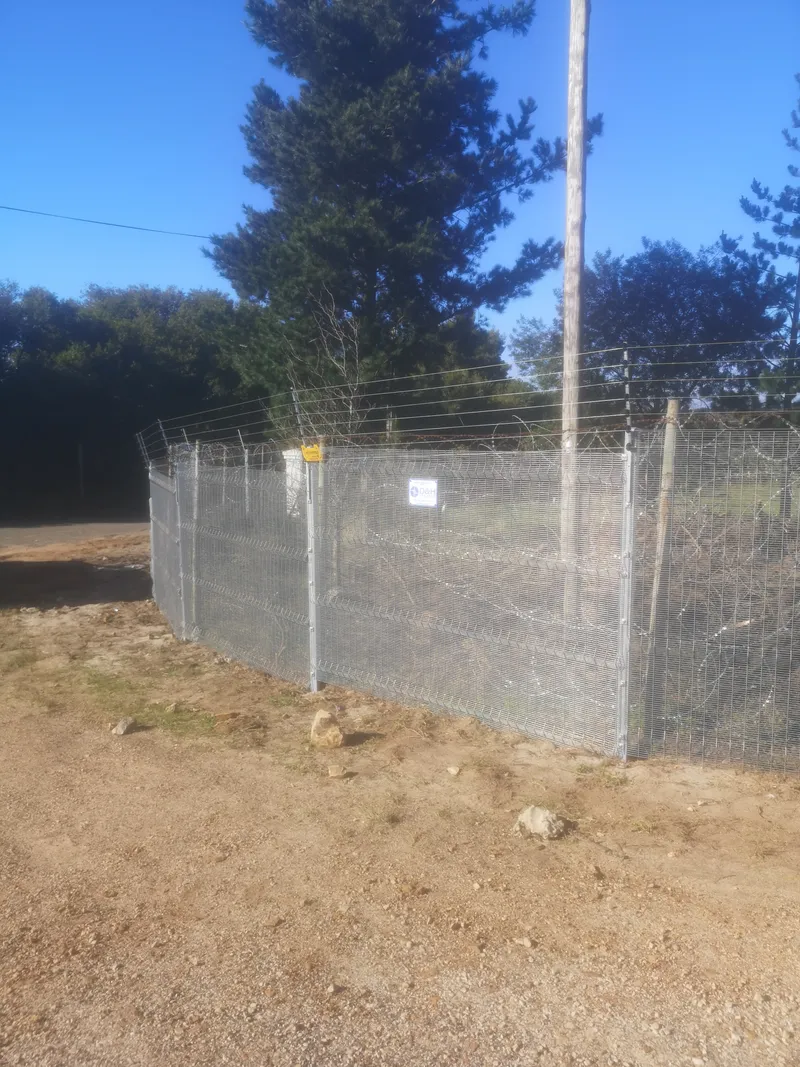 Galvanised clearview anti-climb fence with electric top wires on rural property in Western Cape