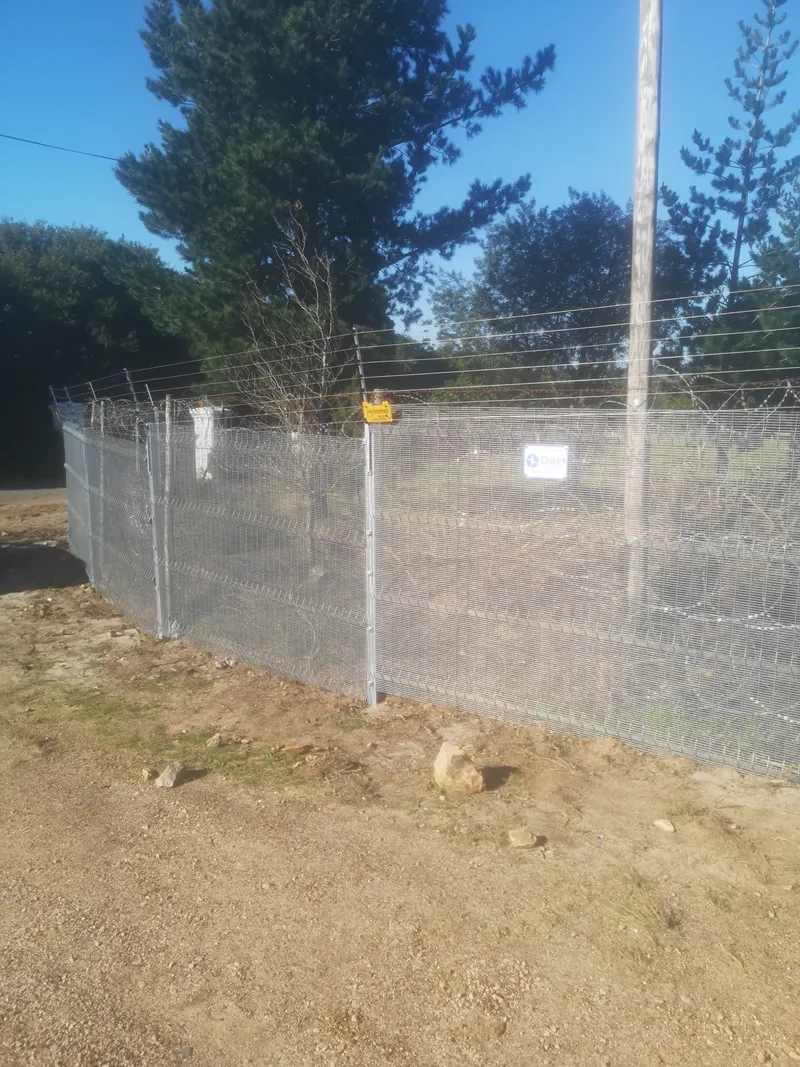 Clearview mesh fence with electric strand top and energizer installed on Cape Town rural boundary
