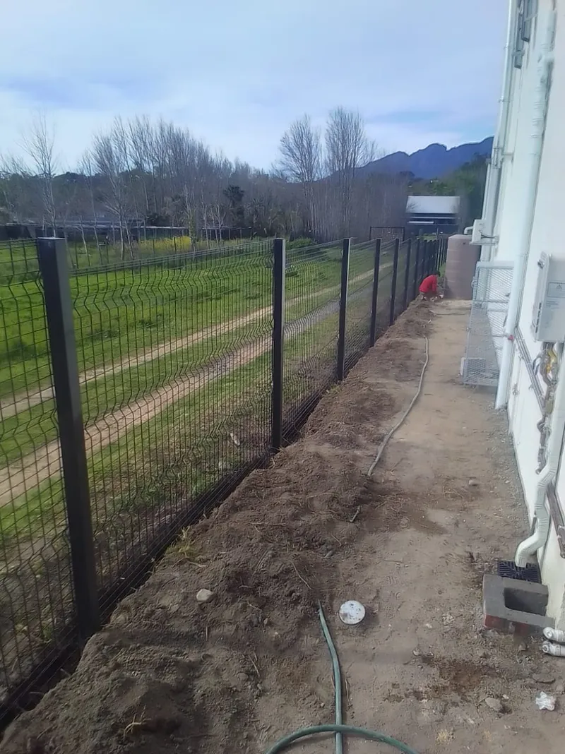 Black Clearview mesh boundary fence at Western Cape winelands residential property with mountain view