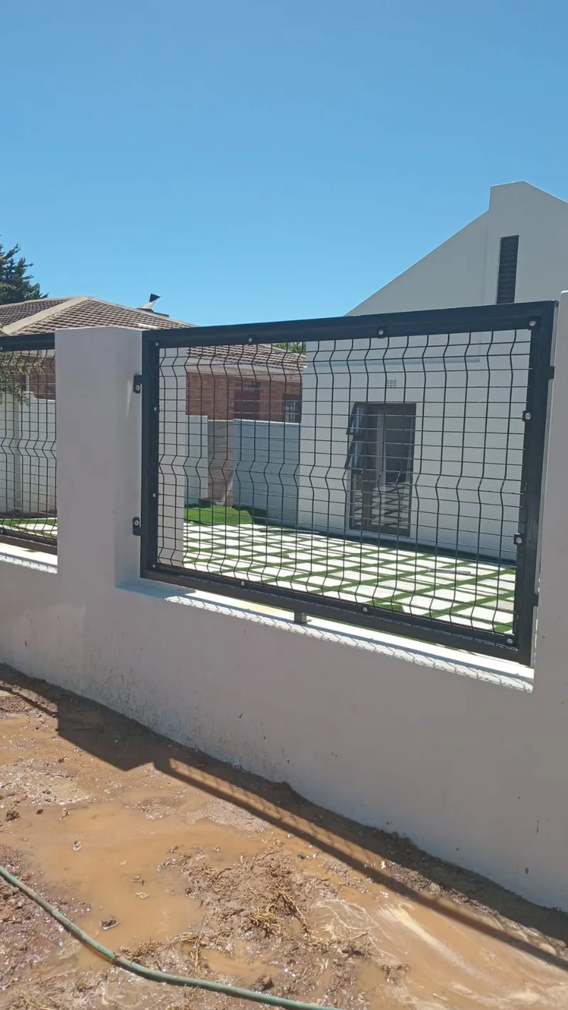 Clearview mesh fence panel mounted on white boundary wall at Cape Town home