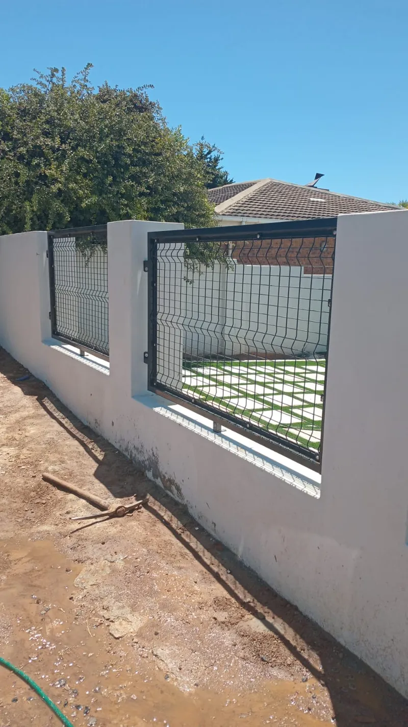 Black clearview mesh panels set into white plastered wall at Cape Town residential property