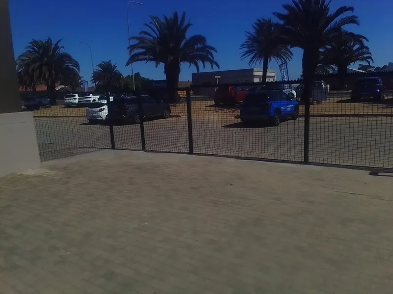 Black clearview mesh fence securing commercial car dealership lot in Western Cape