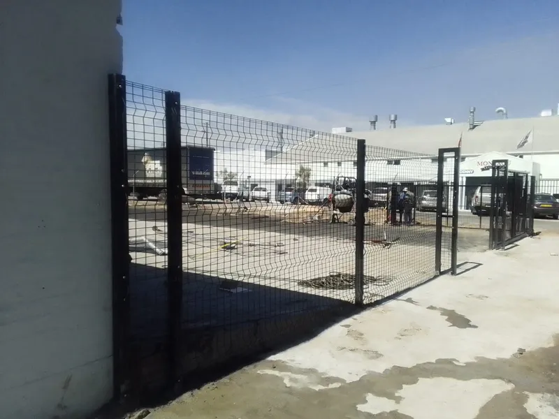 Black clearview mesh perimeter fence with gate at Cape Town commercial yard
