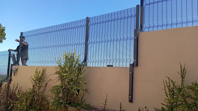 Black clearview mesh wall extension securing residential boundary in Cape Town