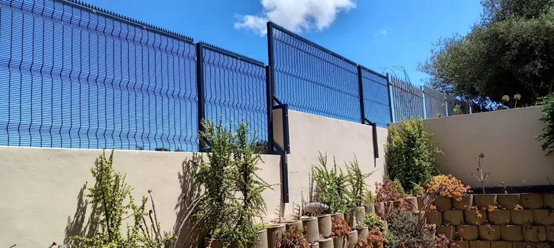 Black clearview mesh wall topper on residential boundary wall in Cape Town garden
