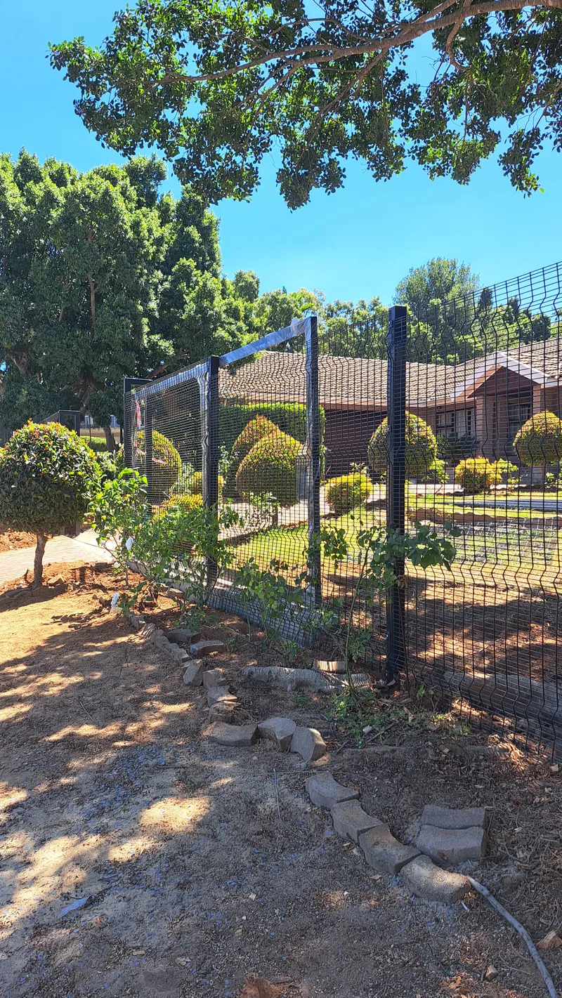 Black Clearview mesh fence installed along a residential garden boundary in Cape Town, Western Cape