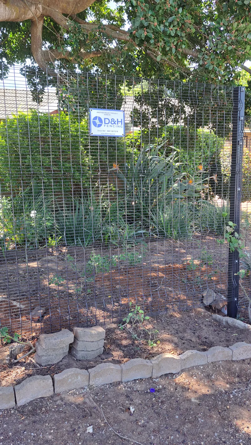 Galvanised Clearview mesh fence with D&H Fencing branded sign at a residential property in Cape Town