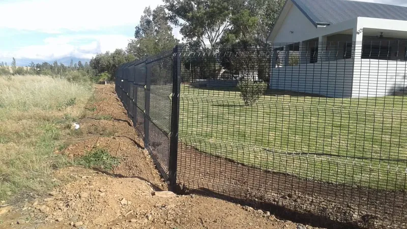Black Clearview anti-climb mesh boundary fence at modern country home in the Western Cape