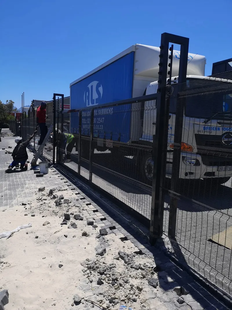Team installing Clearview mesh sliding gate and perimeter fence at commercial logistics yard in Cape Town