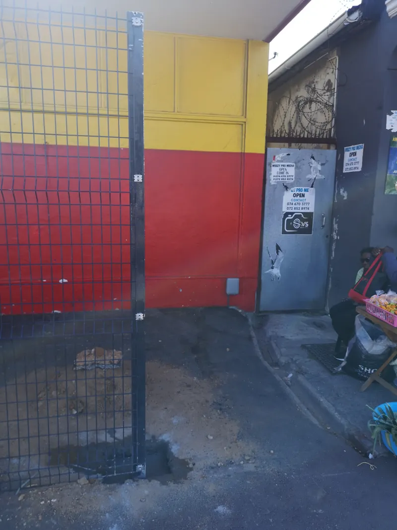 Clearview fence post freshly concreted into pavement during Cape Town install