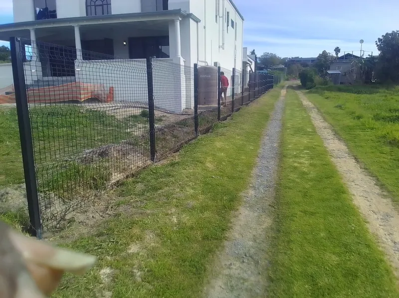 Black Clearview mesh fence boundary on rural Cape Town residential lane