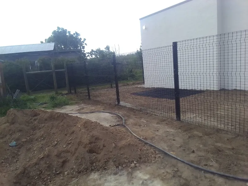 Black Clearview mesh fence and gate installation underway at Cape Town residential property