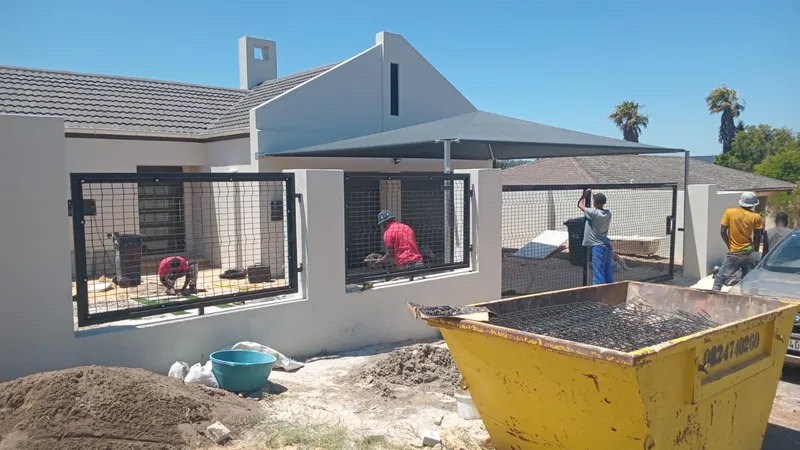 Fencing crew installing clearview mesh panels and gates at Cape Town property