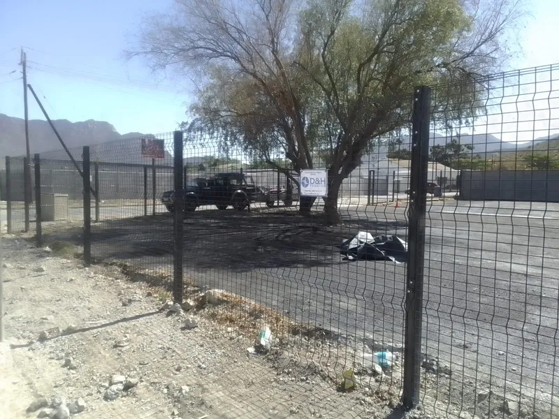 Black clearview mesh fence with D&H Fencing signage at Cape Town commercial site