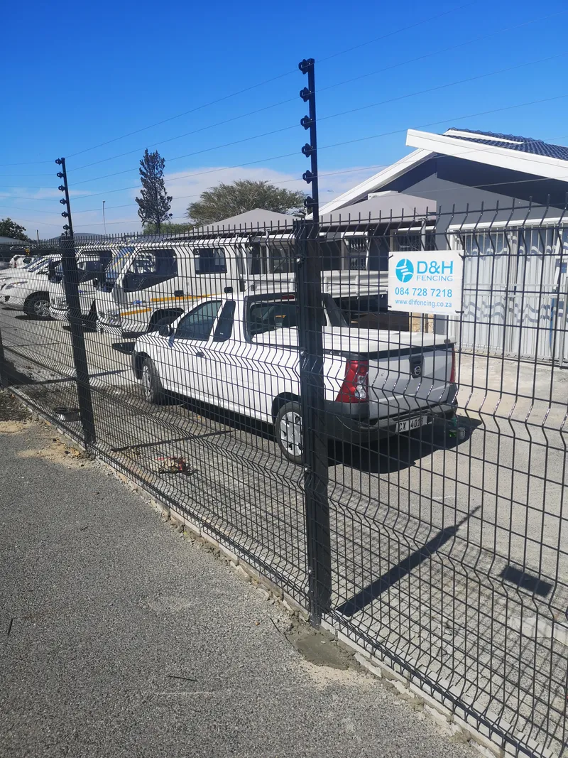 Clearview fence with electric top wires securing commercial vehicle yard in Cape Town