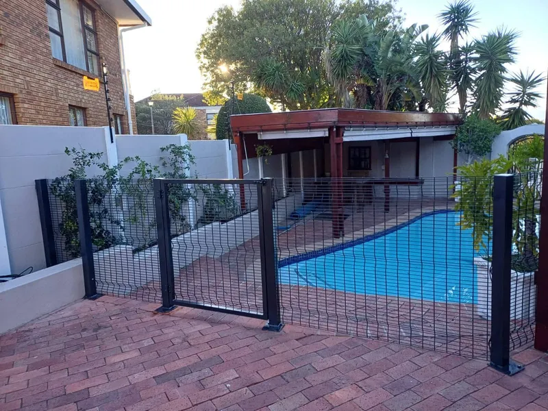 Mesh pool fence with self-closing gate at Cape Town residential swimming pool