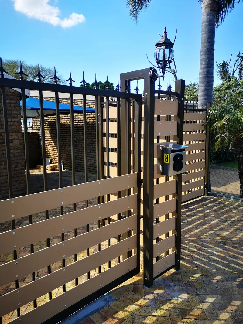 Decorative pedestrian gate with composite slat infill spike tops and house number in Cape Town
