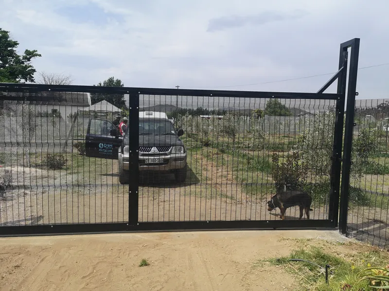 Black Clearview sliding gate with D&H Fencing branded vehicle at Cape Town property