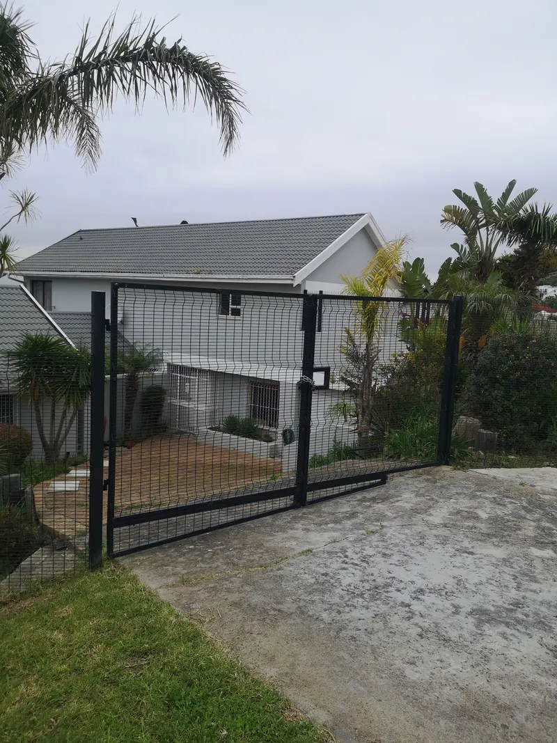 Black clearview mesh driveway gate at suburban home in Cape Town, Western Cape