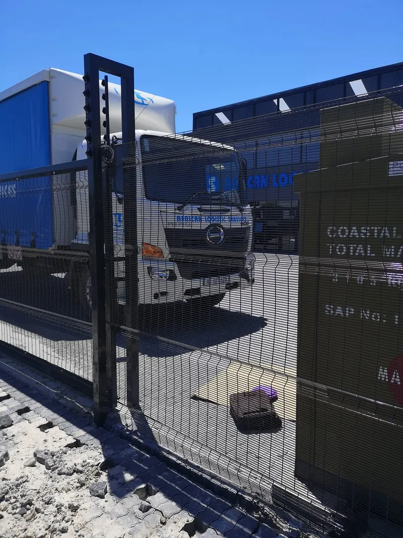 Clearview mesh sliding gate at Cape Town industrial logistics yard with delivery truck