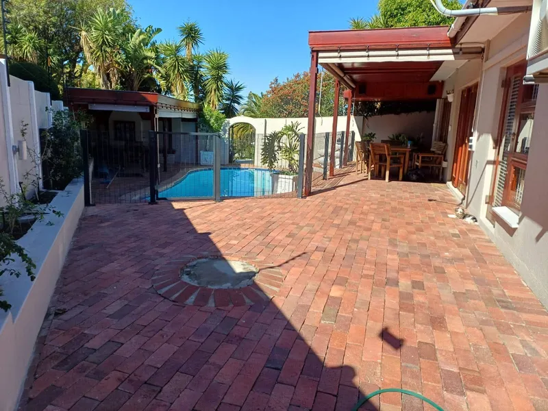 Clearview mesh pool safety fence around residential pool patio in Cape Town garden