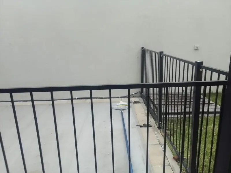 Steel bar pool fence at a Cape Town terrace, welded upright bar corner detail