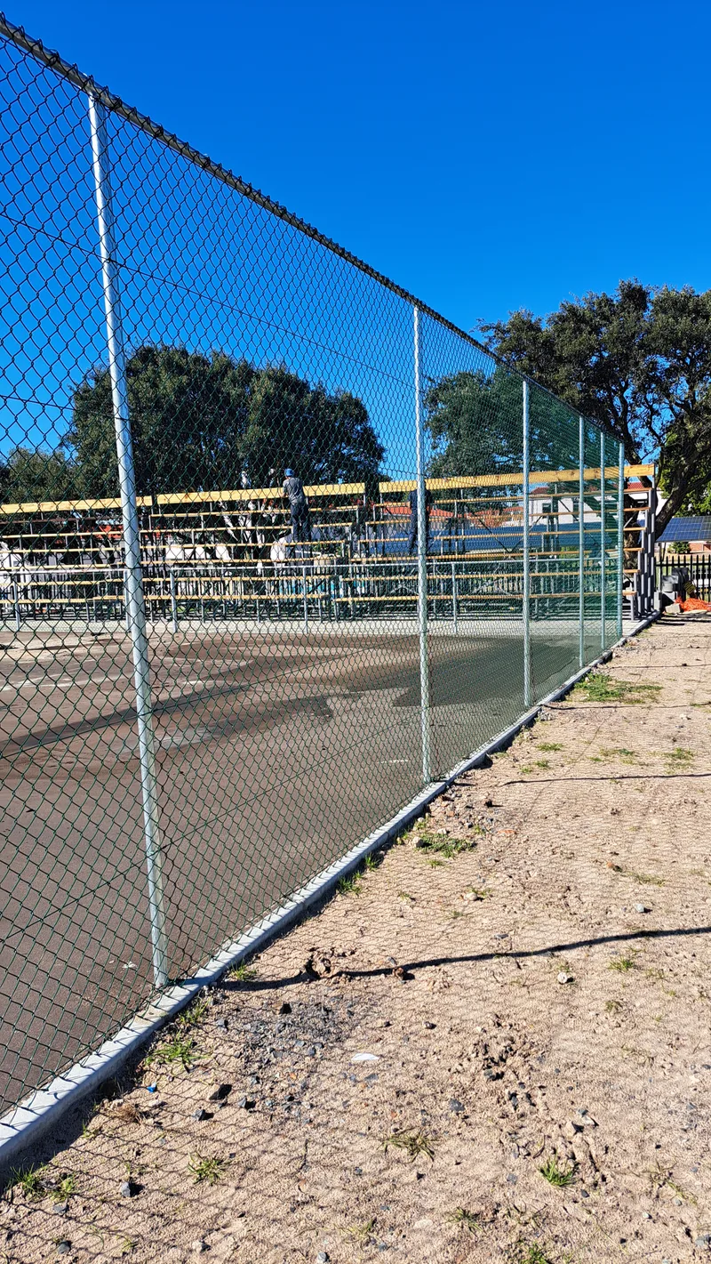 Diamond mesh chain-link perimeter fence along sports ground in Cape Town